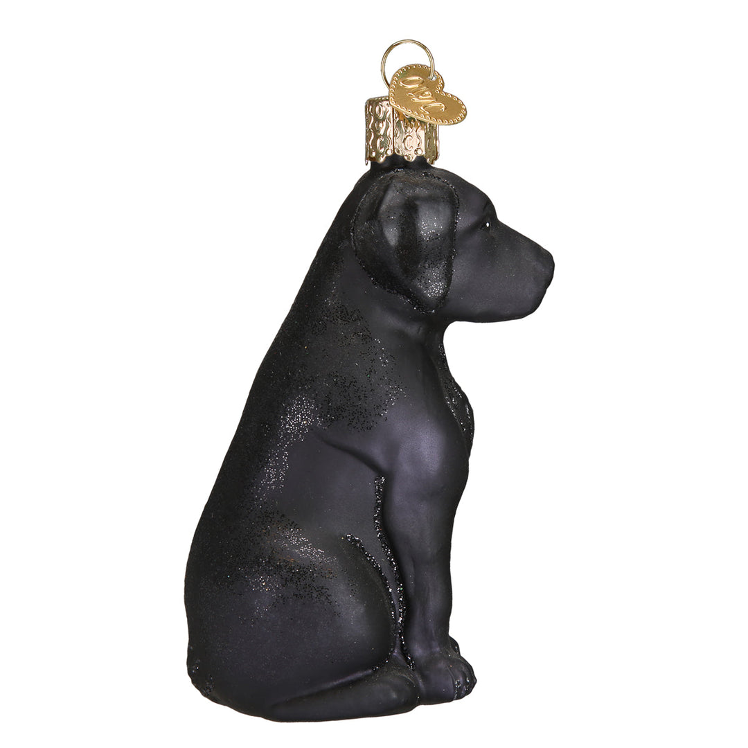 Side profile of the sitting black Labrador ornament showing its soft ears and tail