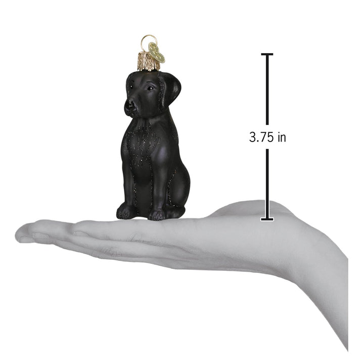 Black Labrador ornament on an open palm with a 3.75 inch height marker for scale