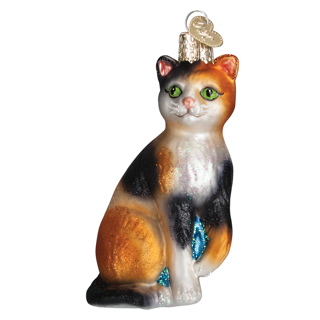 Calico cat glass ornament, front view, orange, black, and white patches with green eyes, on white
