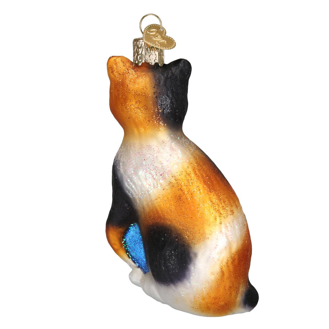 Back view of the calico cat ornament with orange and black patches and a blue glitter accent