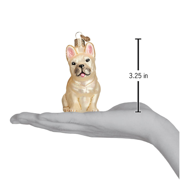 French bulldog ornament on an open palm beside a 3.25 inch height marker