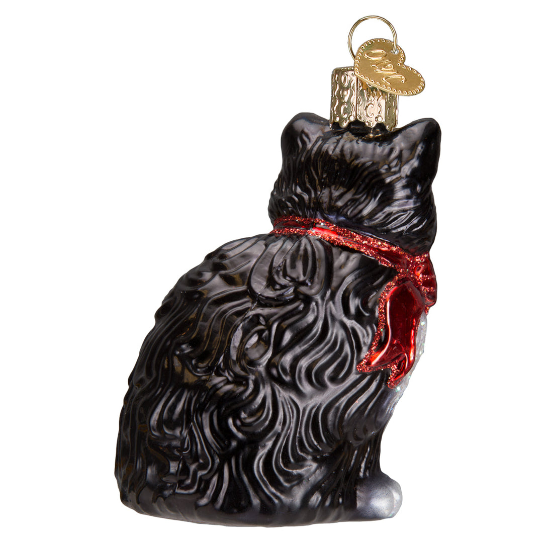 Tuxedo cat ornament, back three-quarter view showing swirled black fur and the red bow tails