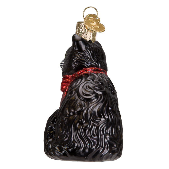 Back view of the tuxedo cat ornament, all black fur with the red bow tied at the neck
