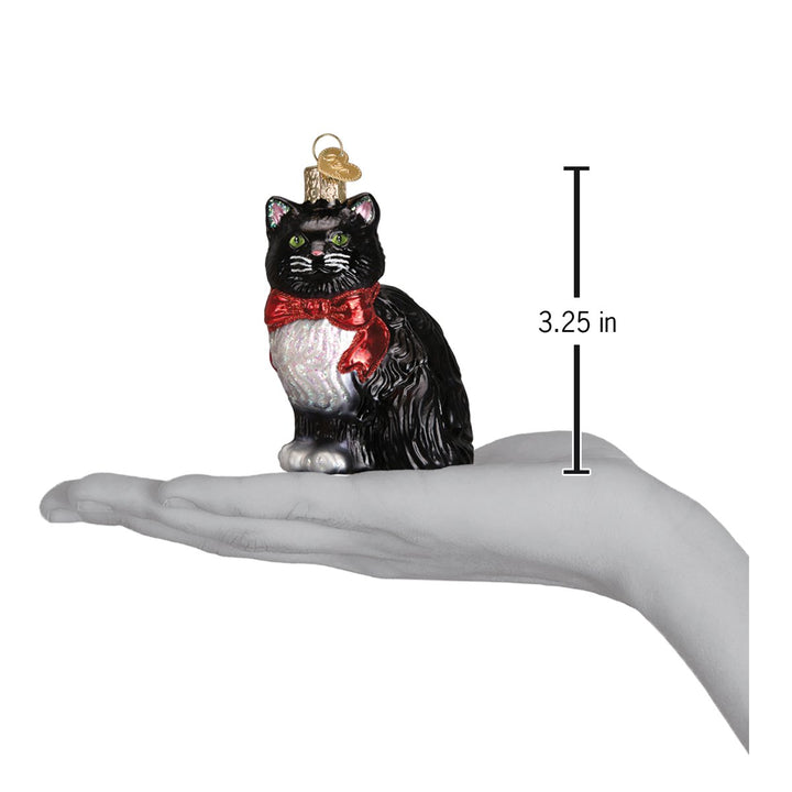 Tuxedo cat ornament resting on an open palm with a 3.25 inch height marker for scale