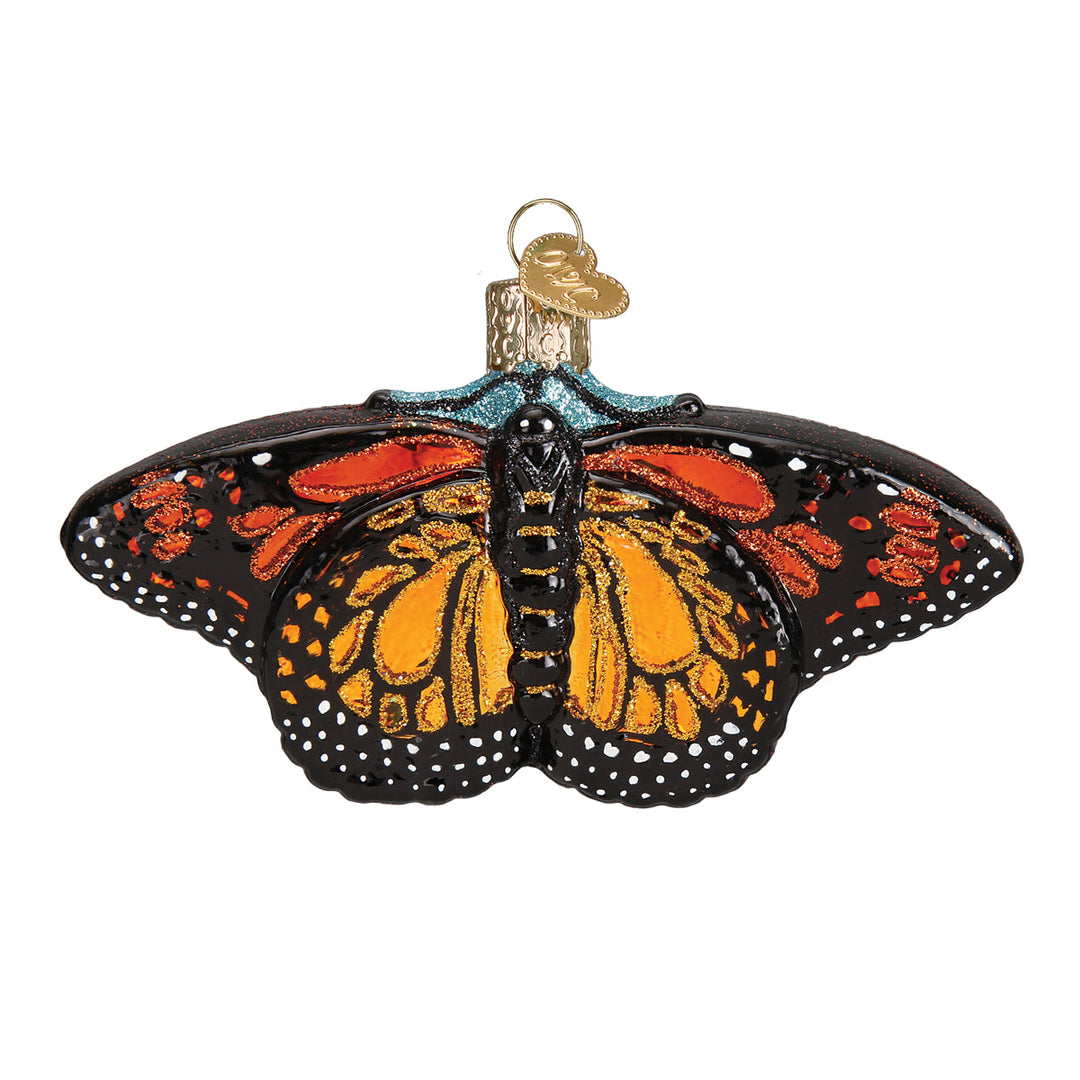 Monarch butterfly glass ornament, front view, orange and black wings with white dotted edges, on white