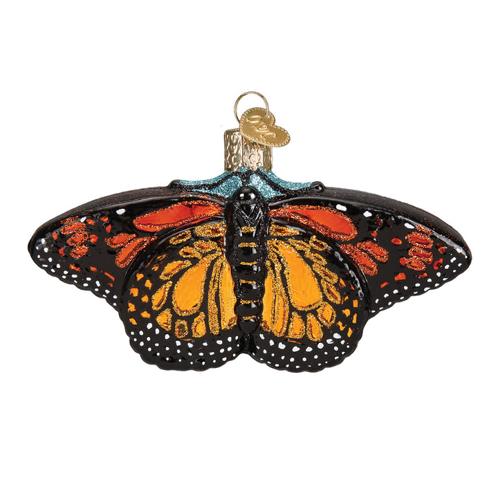 Monarch butterfly glass ornament, front view, orange and black wings with white dotted edges, on white