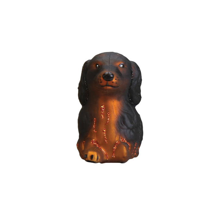 Long haired dachshund ornament seen from the front with feathered ears and tan chest