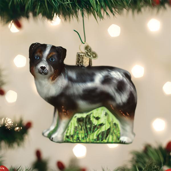 Australian Shepherd glass ornament hanging on a Christmas tree with twinkling lights