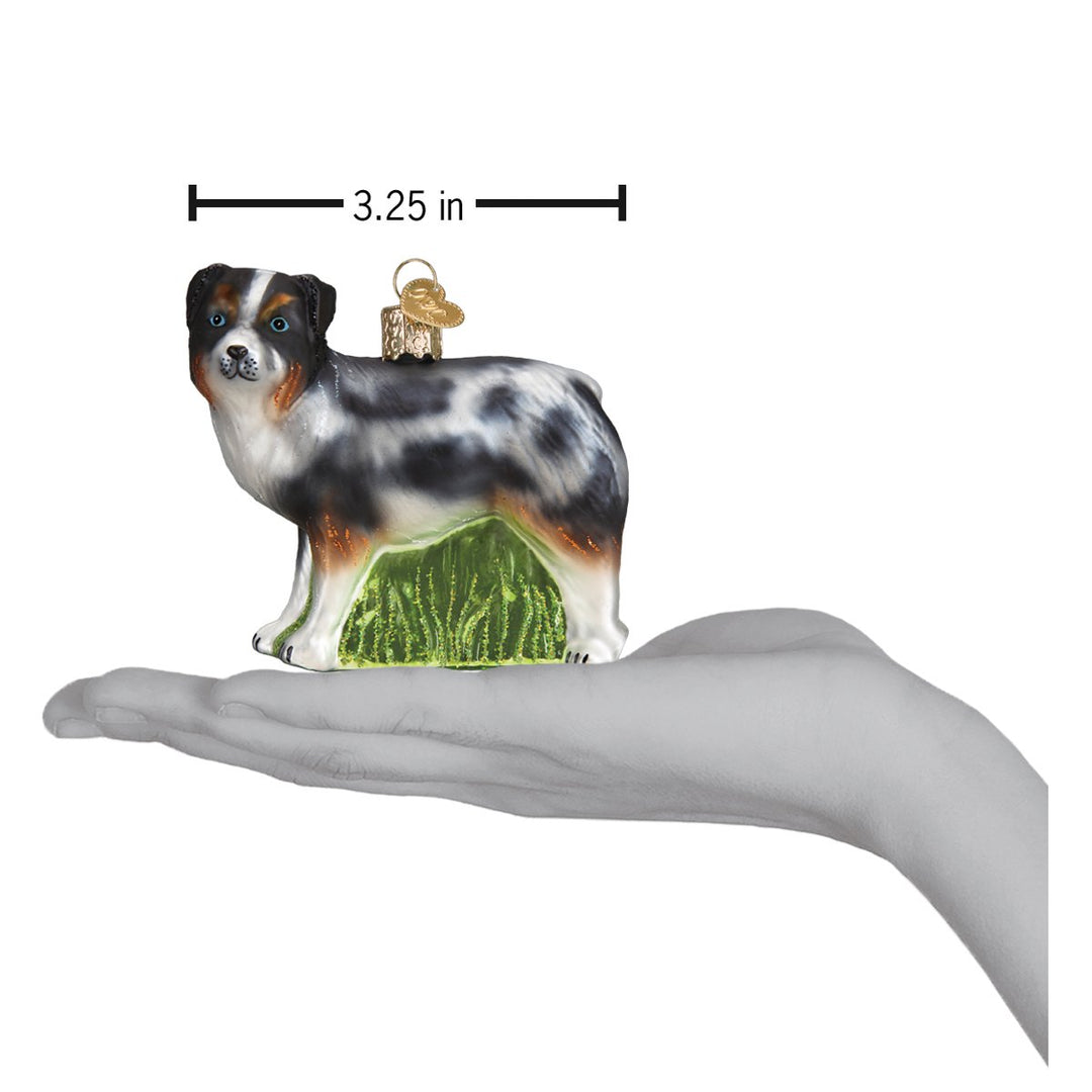 Australian Shepherd ornament on an open palm with a 3.25 inch width marker for scale