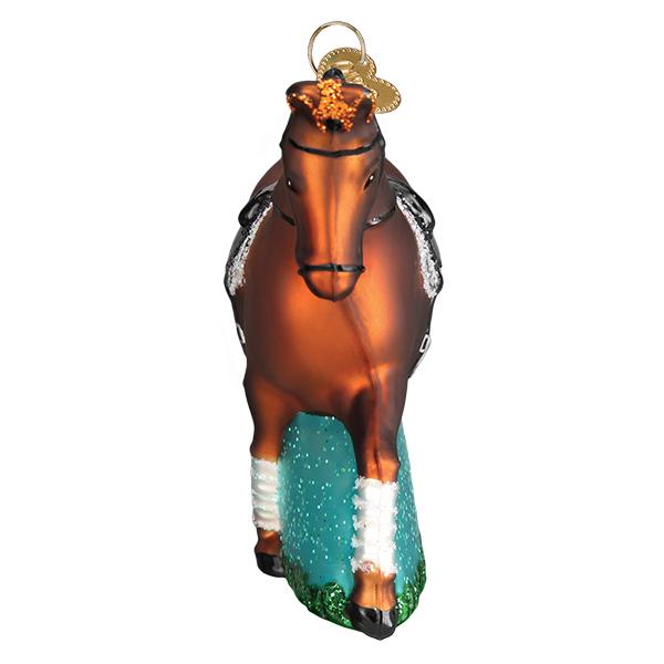 Head-on view of the dressage horse ornament showing the bridle and white leg wraps, on white
