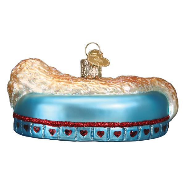Back of the sleepy doodle ornament showing the rounded blue couch and red heart trim