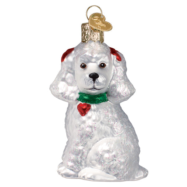 White poodle ornament with red ear bows, a green collar, and a red heart tag on a white background