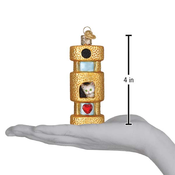 Cat tower ornament on an open palm with a 4 inch height marker for scale