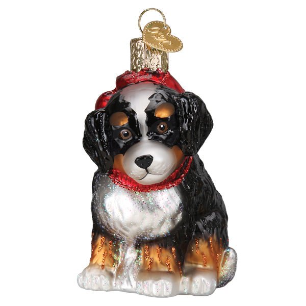 Tricolor Bernedoodle puppy ornament sitting with a red glitter bow and red scarf, front view
