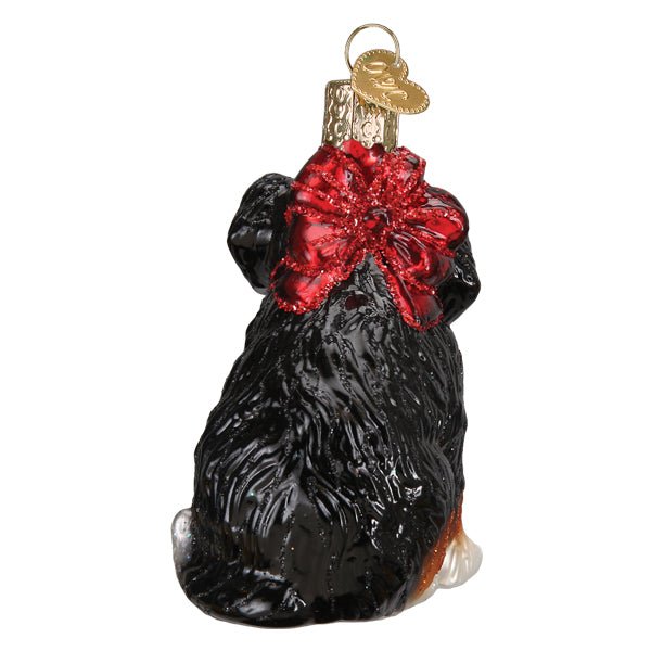 Back view of the Bernedoodle puppy ornament showing the big red glitter bow and black coat