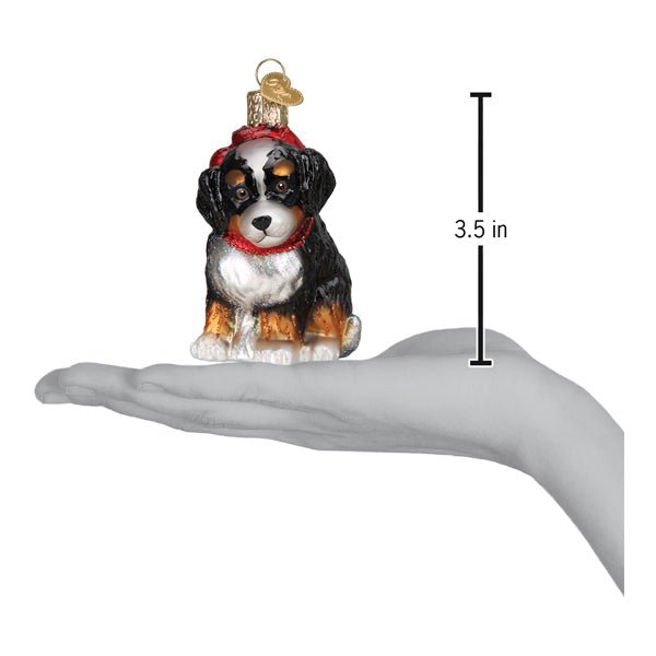 Bernedoodle puppy ornament on an open palm with a 3.5 inch height marker for scale