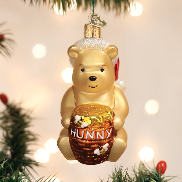 Winnie the Pooh glass ornament holding a Hunny pot for a Christmas tree