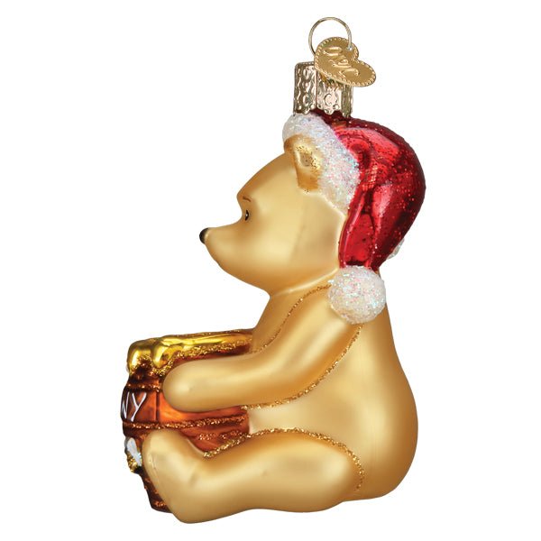 Winnie the Pooh glass ornament holding a Hunny pot for a Christmas tree