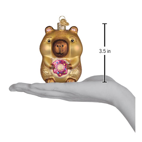 Capybara donut ornament resting on an open palm beside a 3.5 inch height marker