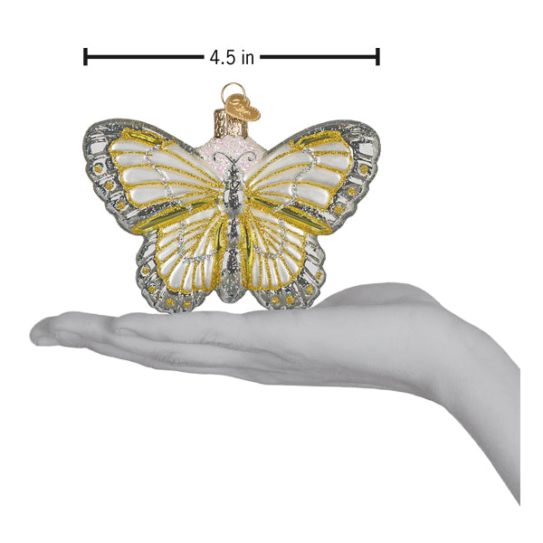 Sterling butterfly ornament on an open palm with a 4.5 inch wingspan marker for scale