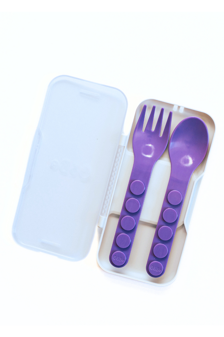 Purple fork and spoon inside the closed snap-together travel case