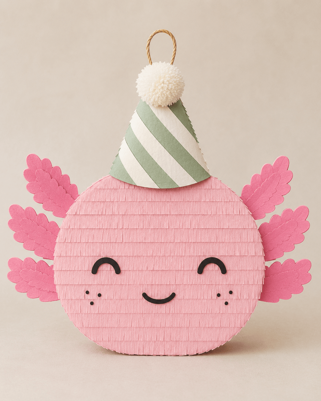 Pink axolotl piñata with hot pink gills, freckled cheeks, and a green striped party hat, for an axolotl birthday party