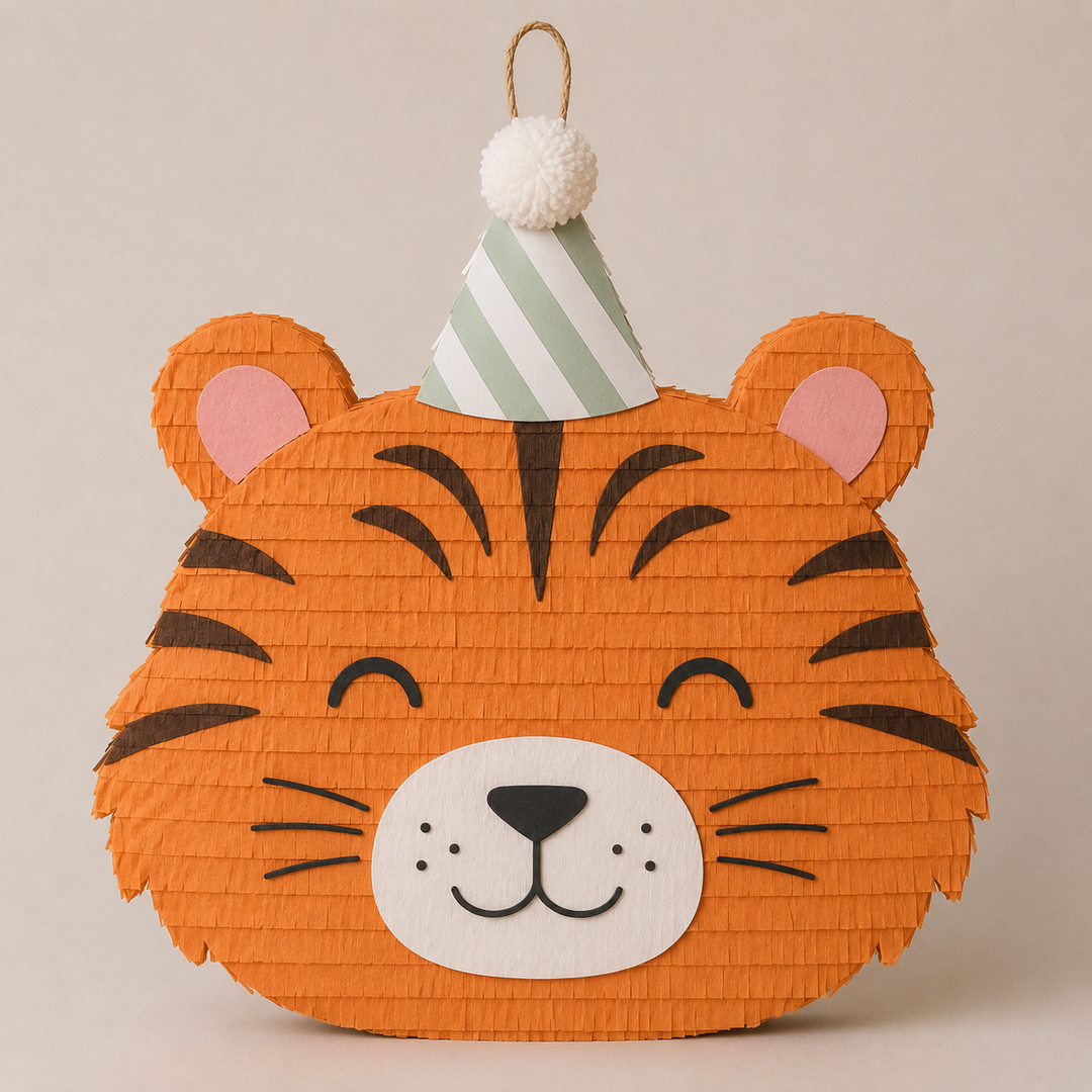 Orange tiger face piñata with dark stripes, whiskers, and a green striped party hat, for a safari or jungle birthday