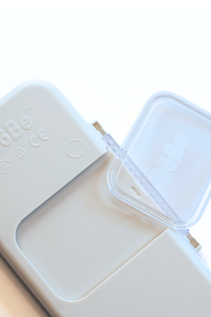 GoBe utensil travel case lifting away from the adhesive lunchbox mount