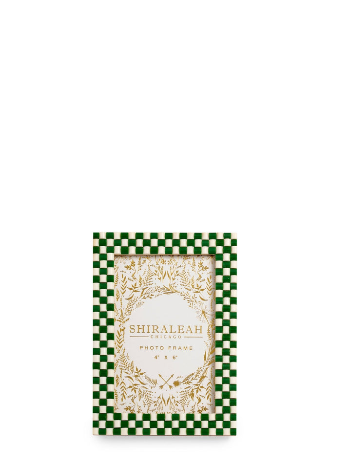 Green and white checkered photo frame with decorative design on a white background