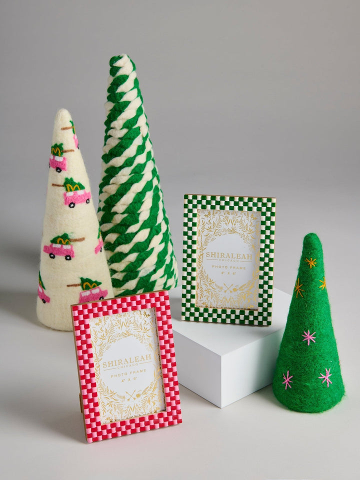 A set of handmade Christmas-themed felt decorations and picture frames by Shireelle Fabrics, including a cream cone with pink trucks, a green-and-white striped cone, a green-and-white checkered frame, a red-and-white checkered frame, and a green cone with pink and yellow stars.