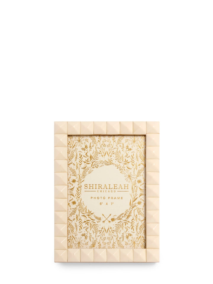 A rectangular photo frame with a textured, quilted cream border and a central floral patterned insert, shown on a plain white background. The brand name 'SHIRALEAH' is printed on the insert.