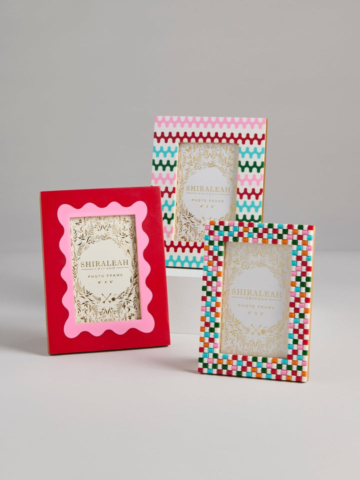 Three Shirelah decorative picture frames displayed on a light gray studio background. The frames feature colorful geometric borders and ornate gold-toned inner plates with the brand name 'SHIRELAH' visible.