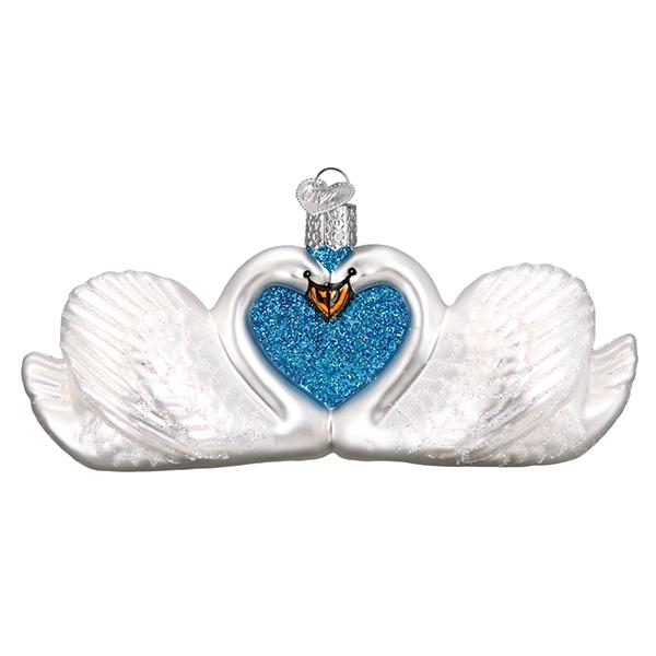 Two white swans ornament with necks forming a blue glitter heart on a white background, front view