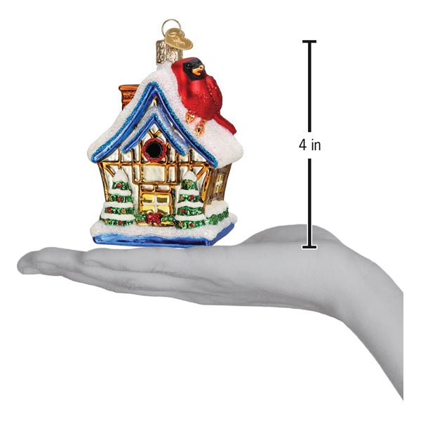Cardinal birdhouse ornament on an open palm beside a 4 inch height marker
