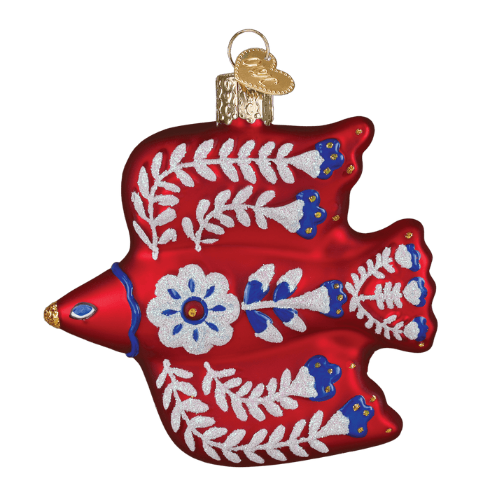 Front of the red folk art thrush ornament painted with white vines, blue blossoms, and a daisy, on white