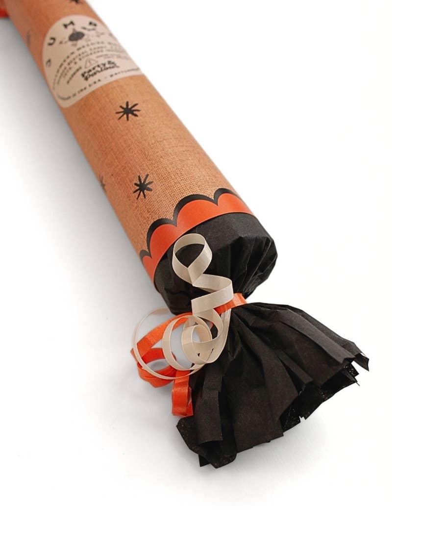 Detail of the kraft Halloween bon bon black tissue fringe and cream ribbon, styled for a Halloween hostess gift