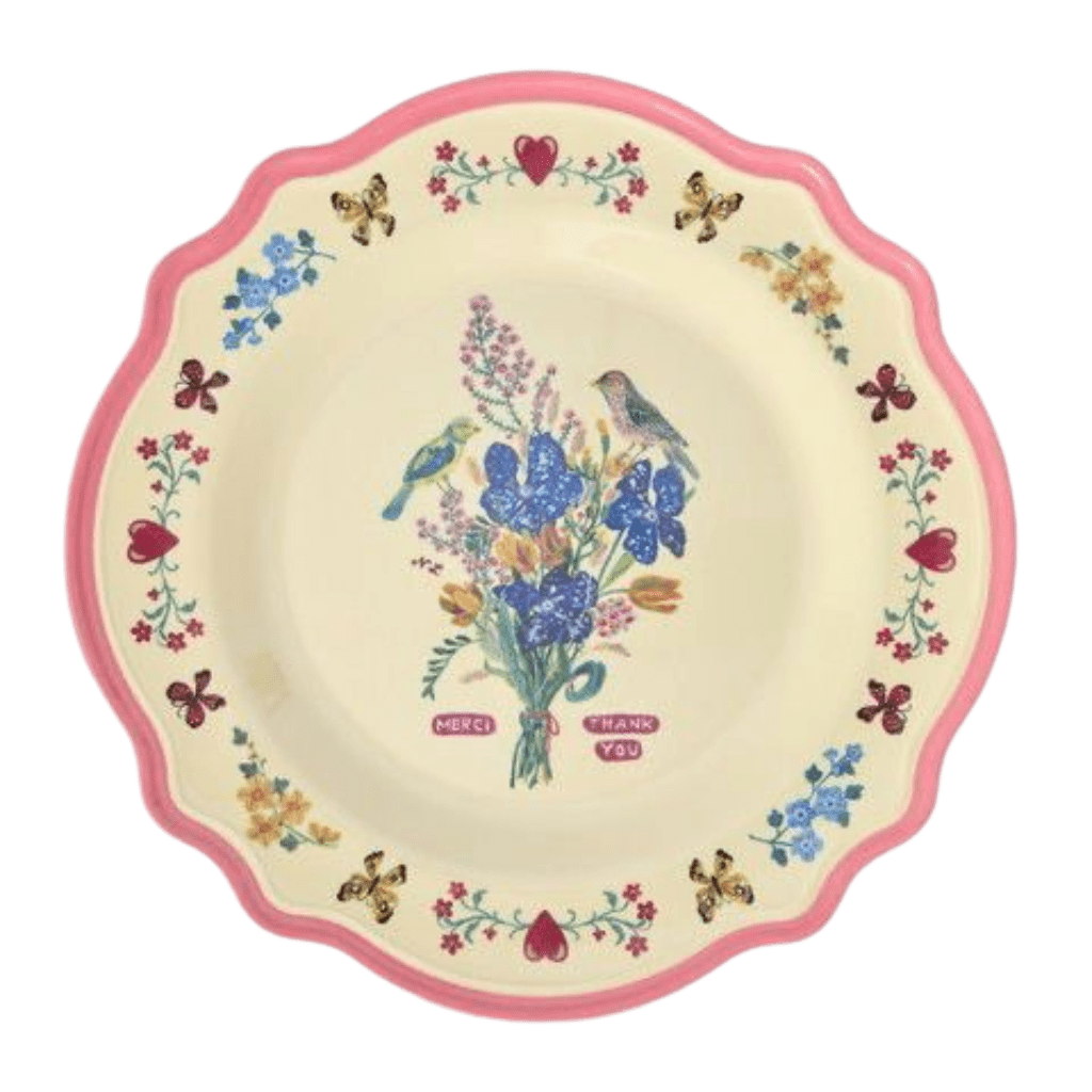 Nathalie Lété melamine dinner plate with a blue and purple wildflower bouquet and bird, neon pink scalloped rim, top view