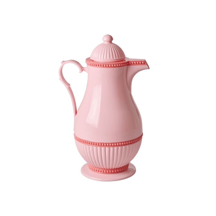 Pink Rice Thermo jug with a domed lid, curved handle, beaded band, and fluted base, side view on white