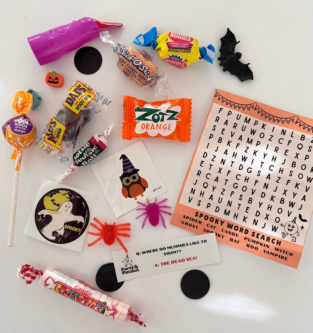 Deluxe Halloween bon bon surprises: lollipops, pumpkin ring, ghost sticker, and a mummy joke card for treat bags