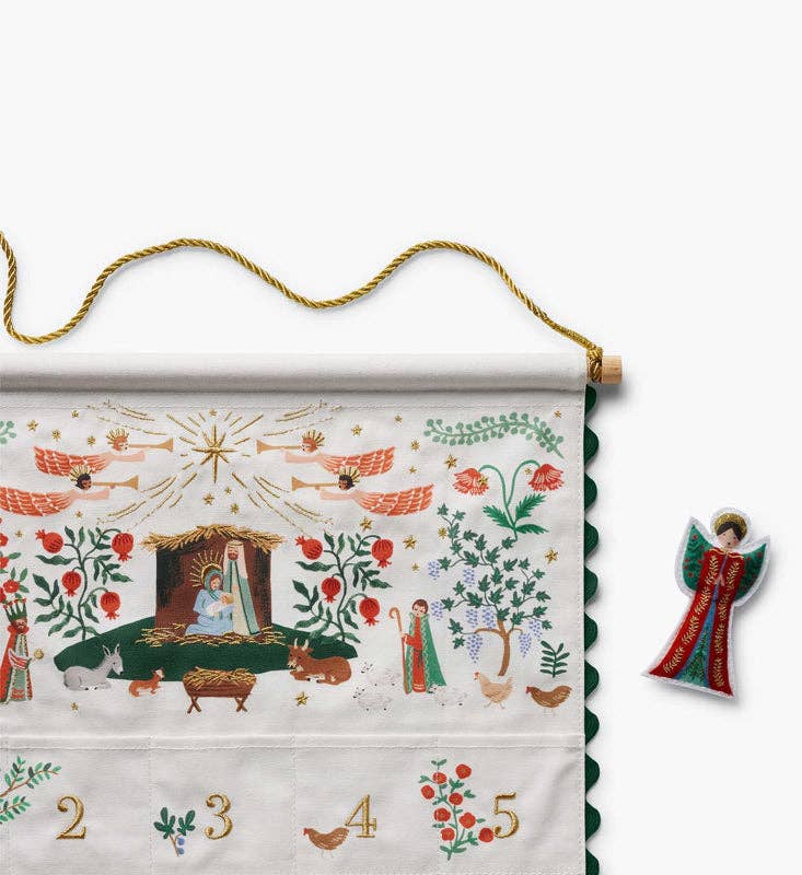 Detail of nativity advent calendar top panel with angels, holy family, magi, and gold rope hanging cord