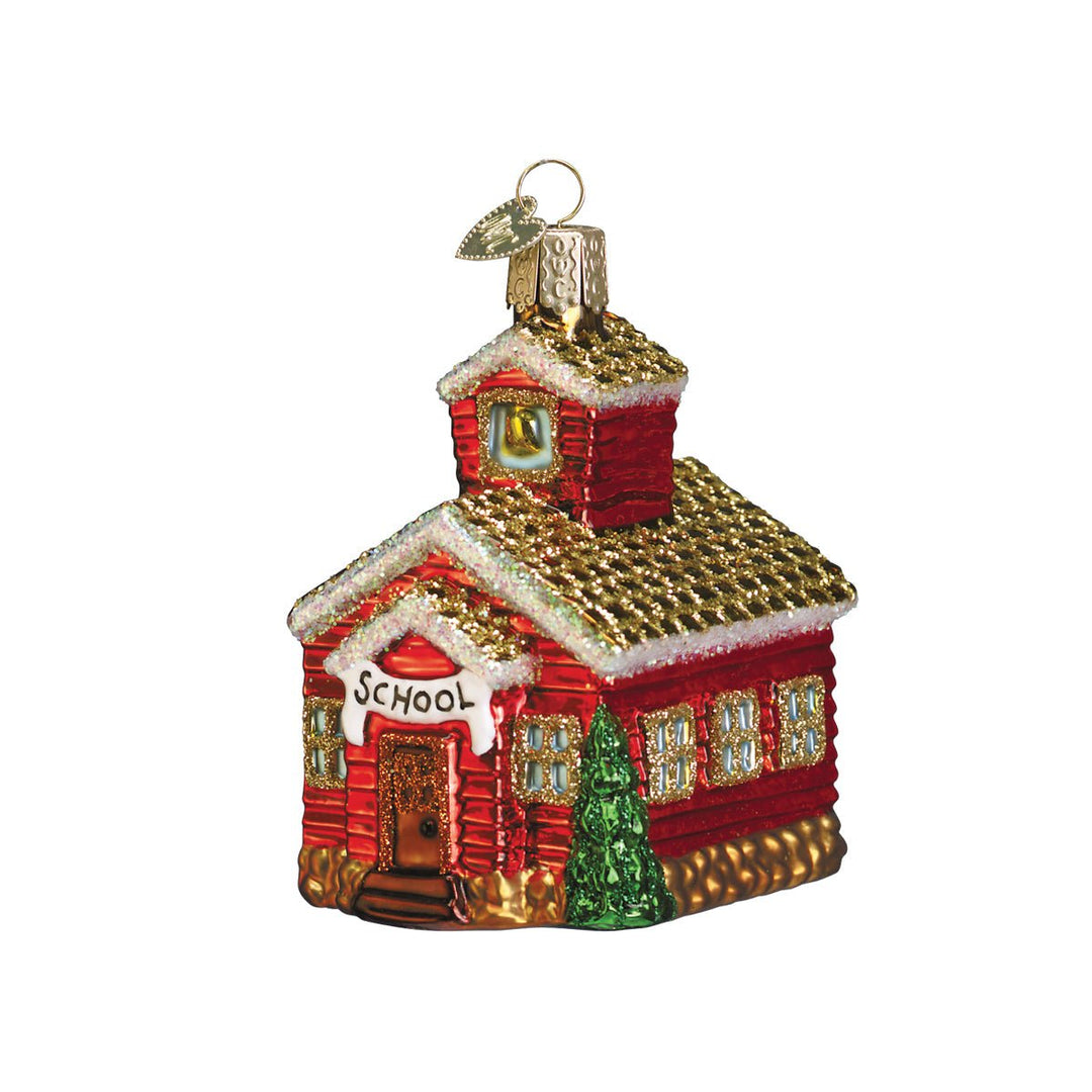 Red schoolhouse glass Christmas ornament with gold glittered roof, bell tower, and SCHOOL sign, front view on white