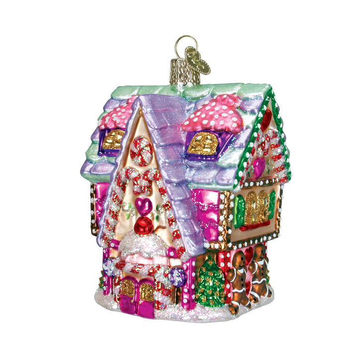 Cupcake cottage ornament front view, lavender frosted roof, candy cane trim, and pink door, on white