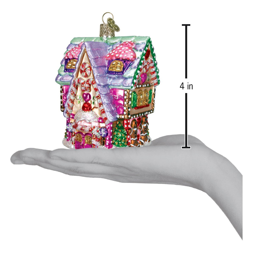 Cupcake cottage ornament on an open palm beside a 4 inch height marker