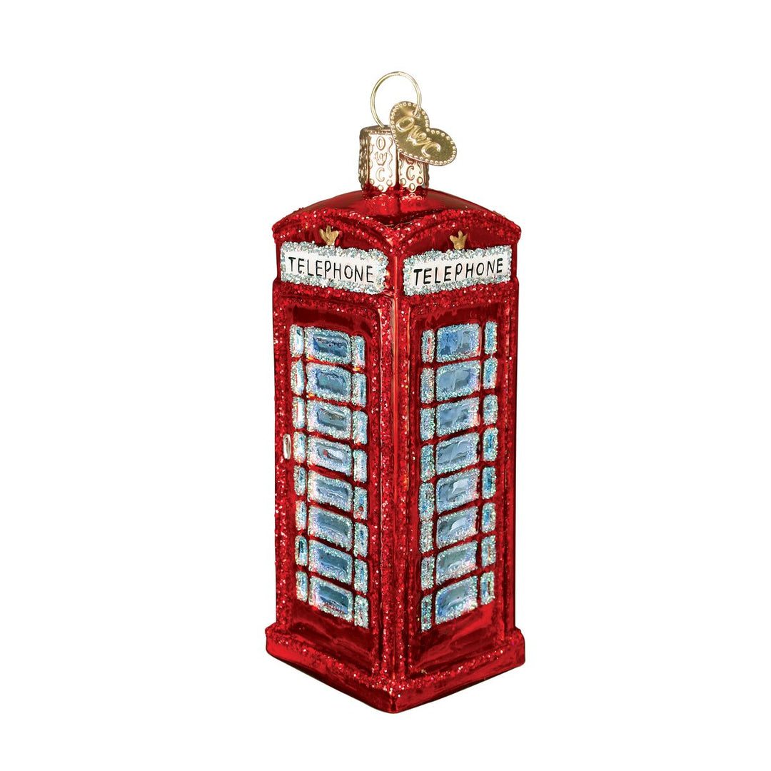 Red London phone booth ornament with blue glass panes and white TELEPHONE signs, front view on white
