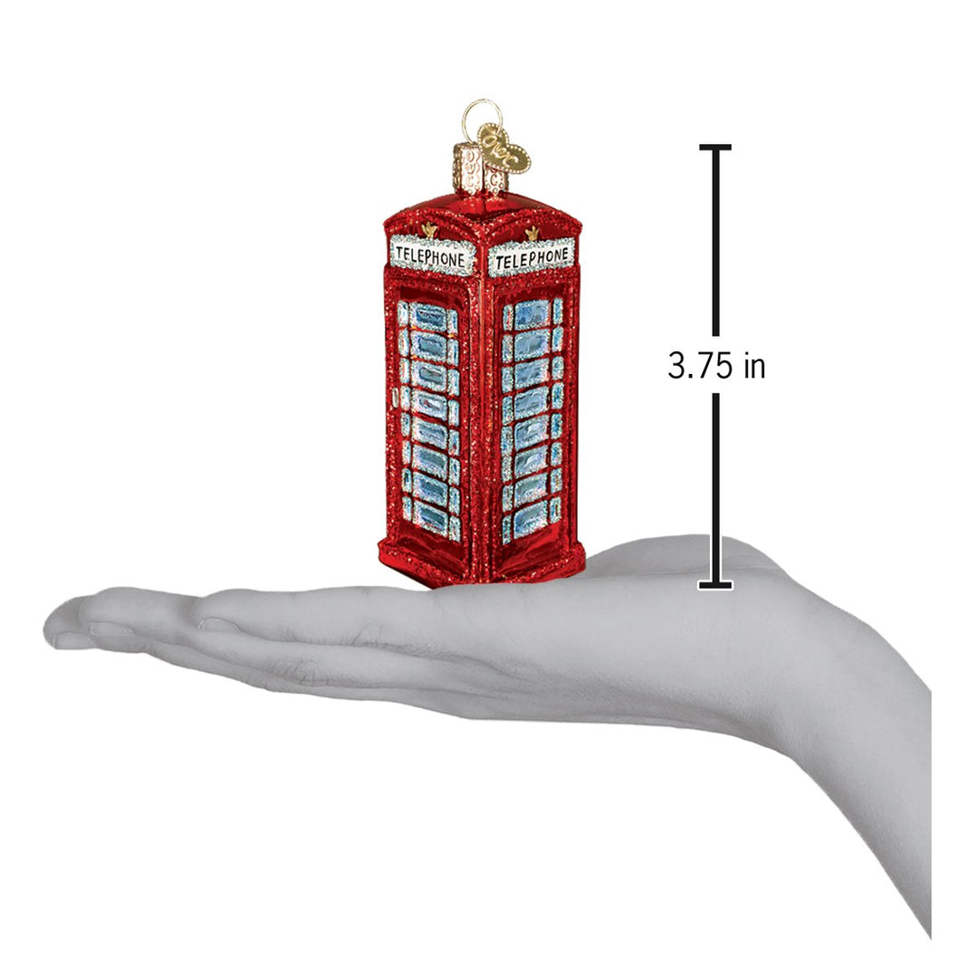 Red phone booth ornament on an open palm beside a 3.75 inch height marker