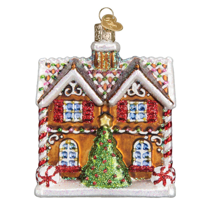 Back of the Christmastime cottage ornament with a glittering green Christmas tree by the wall