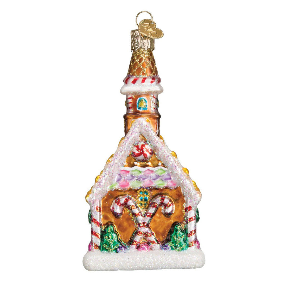 End wall of the gingerbread church ornament with crossed candy canes and pink frosting, on white