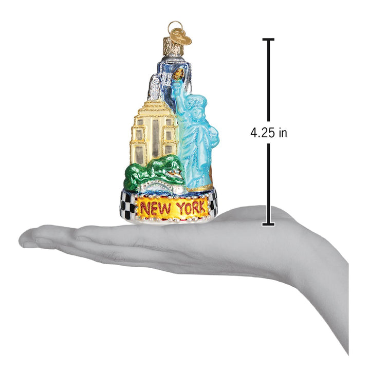 New York City ornament resting on a hand with a 4.25 inch height marker for scale