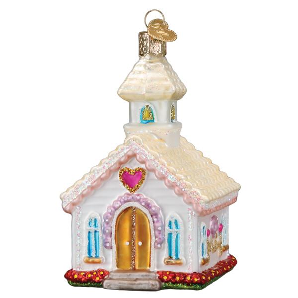 Front of the wedding chapel ornament with a pink heart above arched gold doors and blue windows