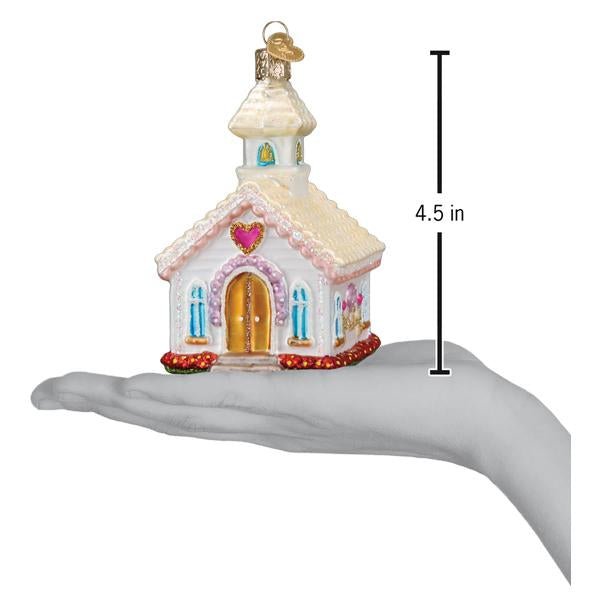 Wedding chapel ornament on an open palm beside a 4.5 inch height marker